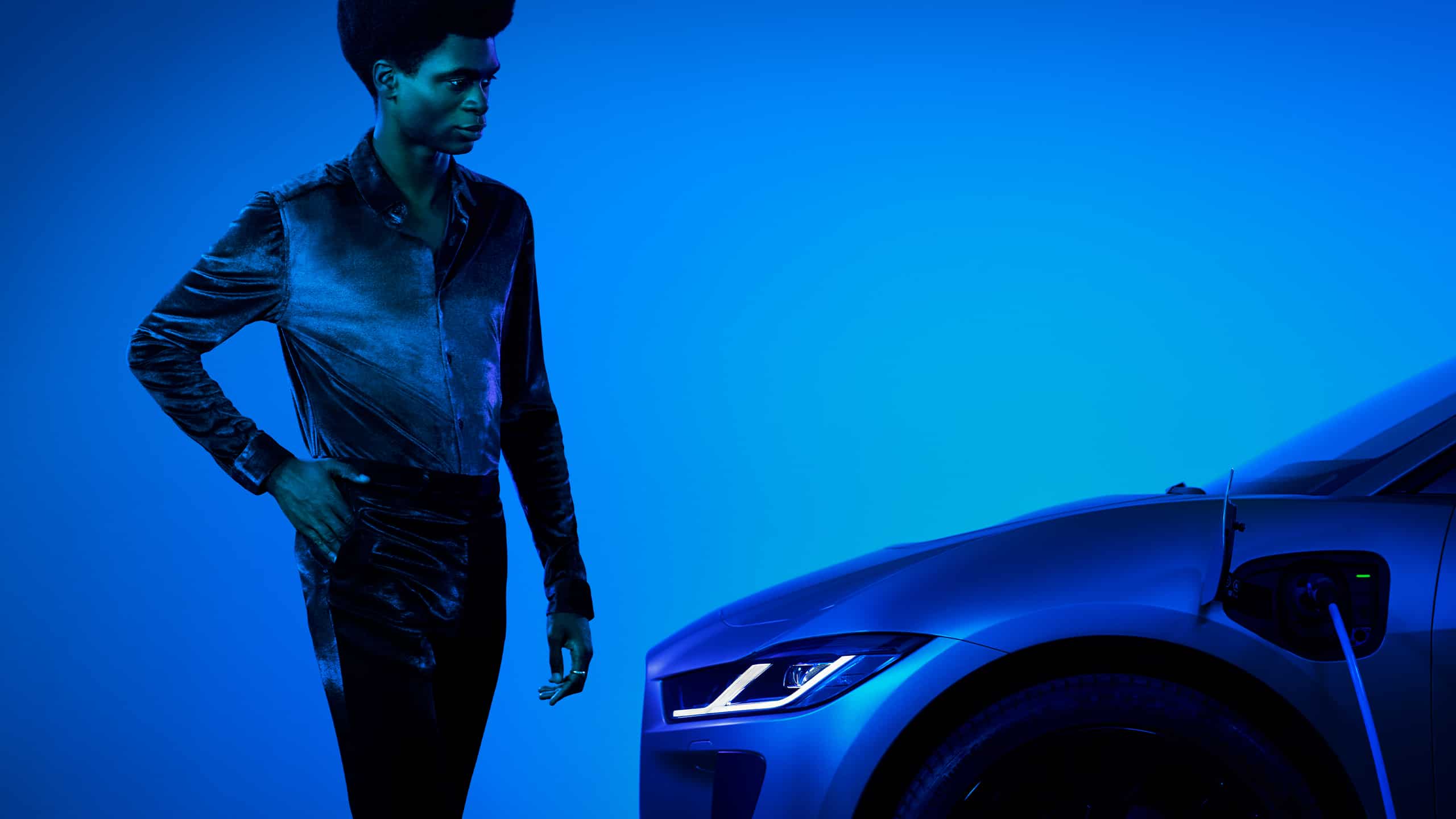 Jaguar I pace PHEV a male model looking at the car