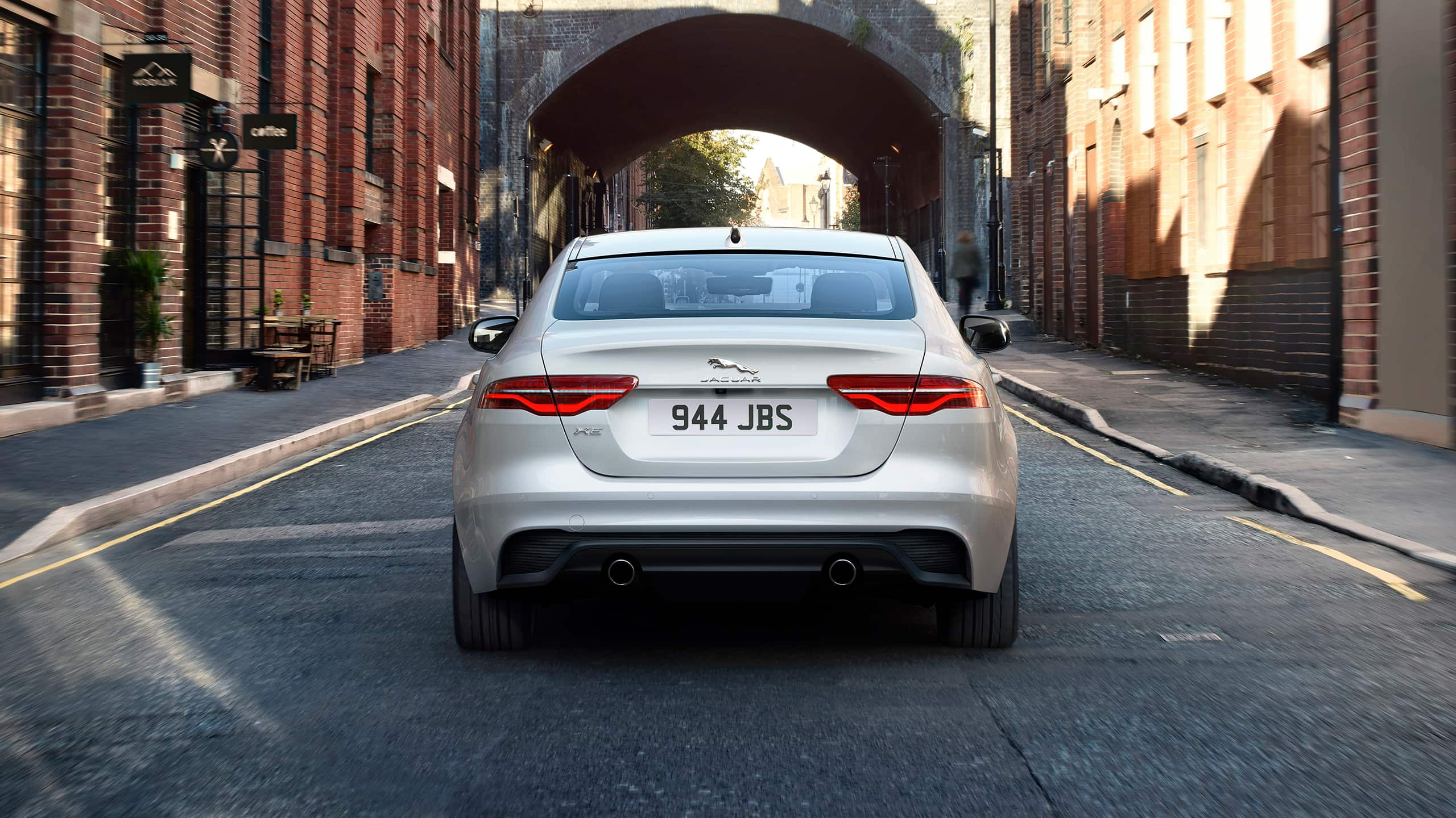 Jaguar running on street near coffee shop